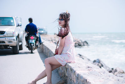 Full length of woman by sea against sky