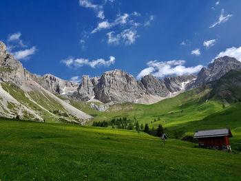 Scenic view of field and mountains against sky in the dolomites