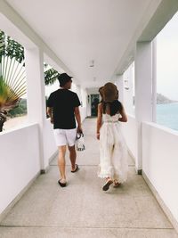 Rear view of people walking in corridor