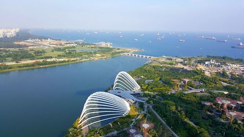 High angle view of buildings by sea against sky