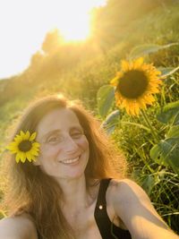 Portrait of smiling woman with sunflowers 