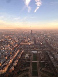 Aerial view of city buildings against cloudy sky