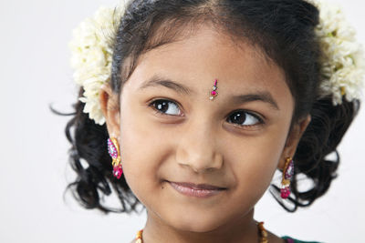 Smiling girl looking away over white background