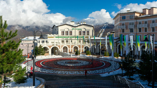 Buildings in city against cloudy sky