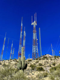 Low angle view of windmill against clear blue sky