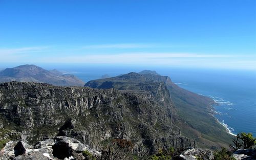 Scenic view of mountains against blue sky