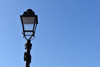 Low angle view of street light against clear blue sky