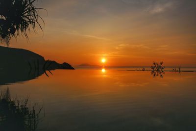 Scenic view of sea against orange sky