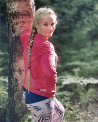 Portrait of girl standing against trees