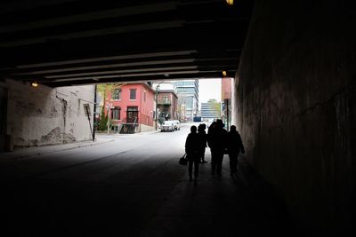 Silhouette people walking in corridor of building