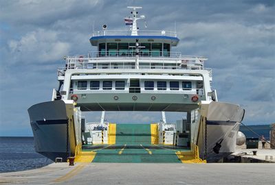 Ferry boat in the harbor against sky