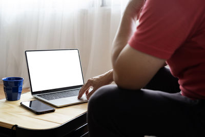 Midsection of woman using mobile phone