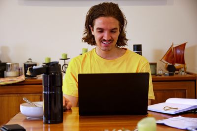 Young woman using laptop at home