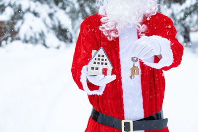 High angle view of santa claus costume standing on snow