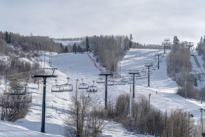 Panoramic view of snow covered field against sky