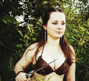 Portrait of beautiful young woman standing outdoors