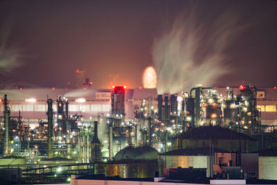 Illuminated city against sky at night