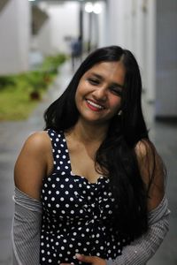 Portrait of smiling young woman standing outdoors