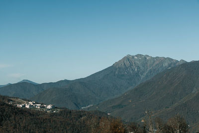 Scenic view of mountains against clear blue sky