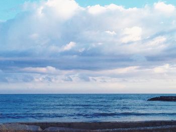 Scenic view of sea against cloudy sky