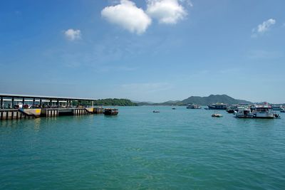 Boats moored in sea against sky