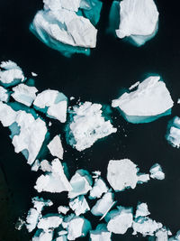 Aerial view of icebergs melting in sea