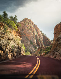 Road amidst rock formation against sky