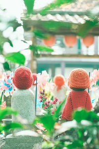 Close-up of red toys with flowers in background