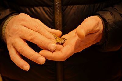 Close-up of human hands holding coins