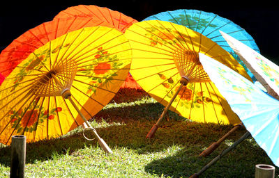 Multi colored umbrellas on field