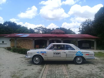 Vintage car on road against sky