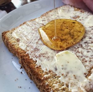 Close-up of honey on bread in plate