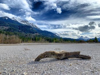 Scenic view of land and mountains against sky
