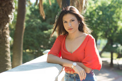 Portrait of beautiful young woman standing outdoors