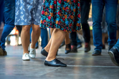 Low section of people standing on floor