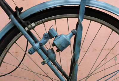 Close-up of bicycle against wall