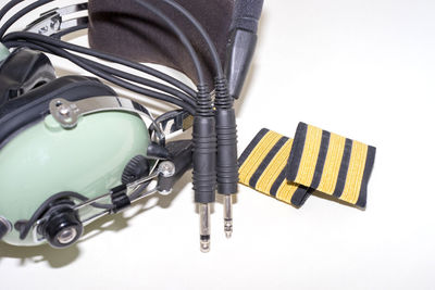 Close up of headphones with cables over white background