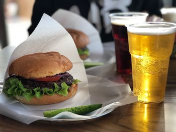 Close-up of drink and burger on table