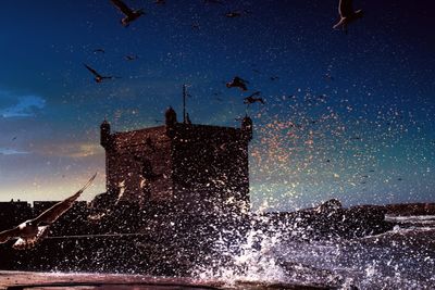 Low angle view of sea against sky at night