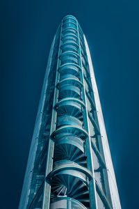 Low angle view of modern building against blue sky