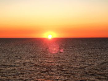 Scenic view of sea against romantic sky at sunset