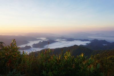 Scenic view of mountains against sky at sunset