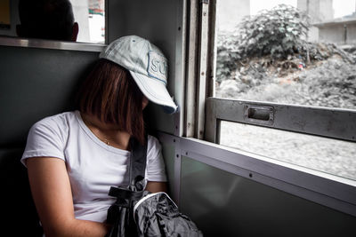 Woman by window in train