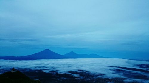 Scenic view of mountains against blue sky