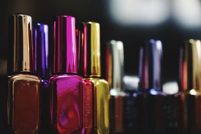 Close-up of multi colored bottles in row