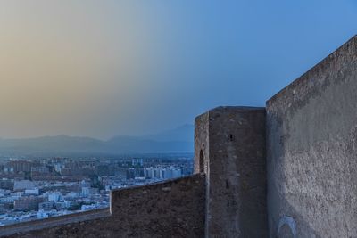 Historic buildings against clear sky during sunset