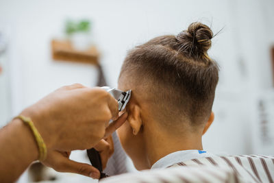 Side view of young woman using phone