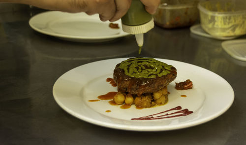 High angle view of person preparing food in plate