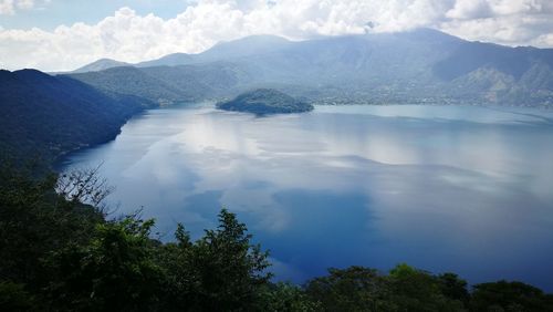 Scenic view of lake and mountains against sky