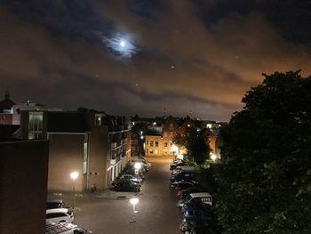 Illuminated city against sky at night